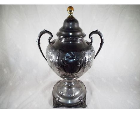 A 19 century large white metal samovar with scrolled and foliate relief decoration throughout, brass tap, the cover with ball