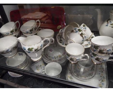 A quantity of ceramic tableware by Delphine, comprising white with floral decoration and powder blue (qty)