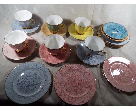 24 pieces of Royal Albert bone china table ware entitled Gossamer, various marbled coloured with gilded borders