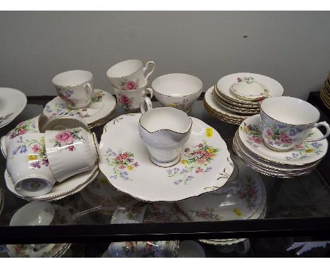 A quantity of ceramic table ware by Queen Anne decorated in the Old Country Spray pattern and by Royal Stafford decorated in 