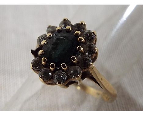 A lady's 9ct hallmarked gold cluster ring the central smoky topaz stone surround by CZ approximate weight 2.22 grams - Est £2
