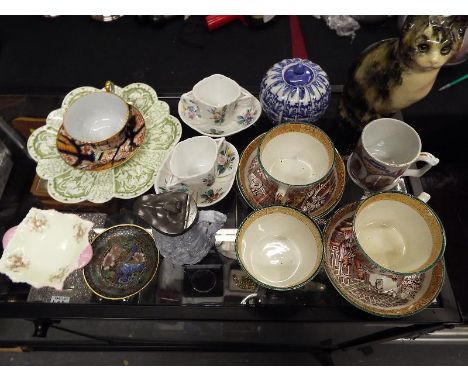 A good mixed lot to include three lustreware cups and saucers from the Ralph Hammersly factory, a Spode cup and saucer, a blu