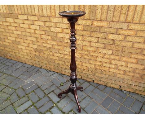 A dark wood torchere with tripod supports 121 cm (h) 