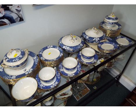 A Copeland Spode blue and white ceramic dinner service, decorated with gilded highlights comprising approximately 56 pieces (
