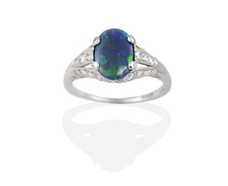 A Circa 1925 Art Deco Black Opal and Diamond Ring, an oval cabochon opal in a claw setting, to forked old cut diamond set sho