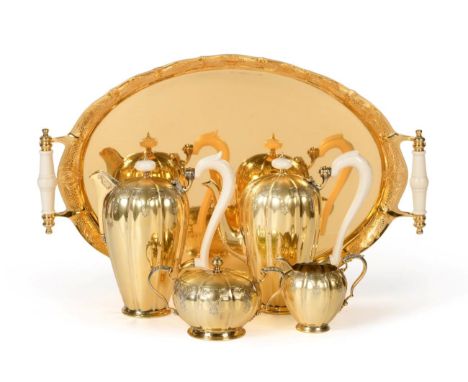 A Silver Gilt Four Piece Coffee Service with Twin Handled Tray En Suite, Garrard &amp; Co, London 1975/76, melon fluted and w