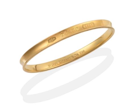 A Tiffany 1837 Bangle, of grooved design, stamped to the outside '750', 'T&amp;CO', '1837', measures 6cm by 5.2cm inner diame
