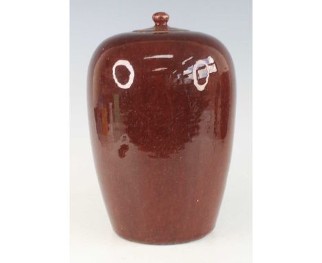 A Chinese Jiaqing period (1796-1820) large sang-de-boeuf glazed stoneware storage jar and cover, of slightly shouldered gentl