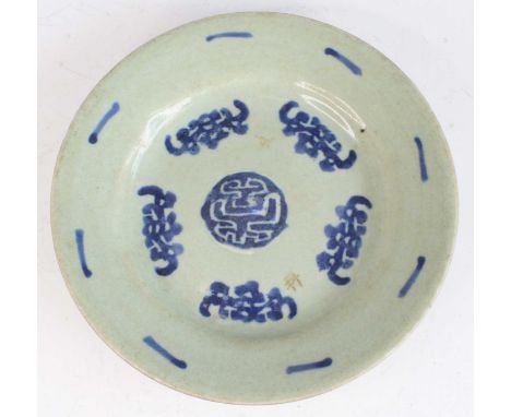 A Chinese pale celadon circular dish, with blue painted motifs, unglazed footrim, with painted character marks and impressed 