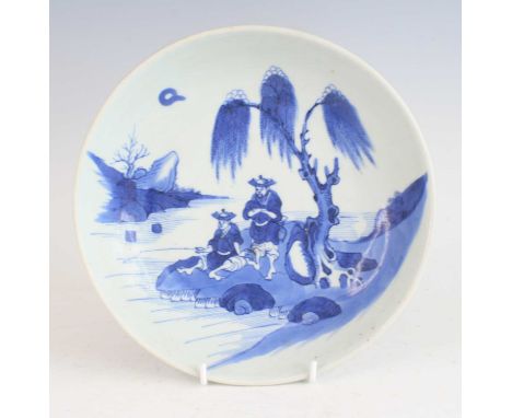 A large Chinese 19th century blue and white stoneware dish, of shallow circular footed form, underglaze painted with fisherme