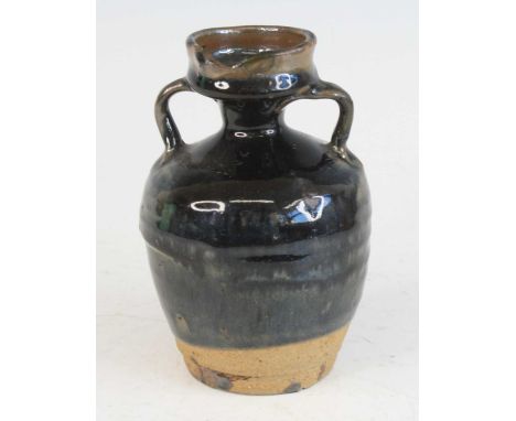 A Chinese glazed stoneware twin handled pitcher, possibly Yuan Dynasty (1271-1368), the body of slightly shouldered tapering 