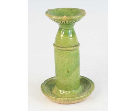 A Chinese green glazed pottery domestic ware oil lamp, probably 18th century, having waisted upper stem to lower circular dis