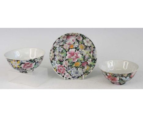 Two similar Chinese Guangxu period (1871-1908) famille noir porcelain footed tea bowls, each exterior heavily floral enamel d