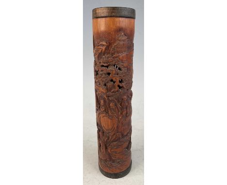 A Chinese carved and pierced bamboo incense holder, of cylindrical form, decorated with figures and pagodas within a mountain