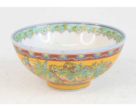 A Chinese Republic period (1912-1949) famille jaune stoneware footed rice bowl, enamel decorated with peaches and auspicious 