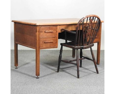 A mid 20th century light oak kneehole desk, together with a wheel back chair (2)136w x 75d x 74h cm