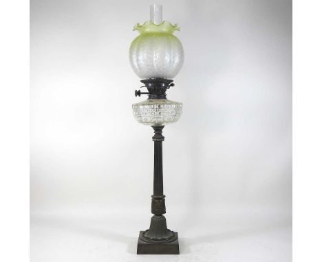 An 19th century cast iron oil lamp, with a yellow shade, 83cm high overallCondition report: Overall looks to be complete. Sha