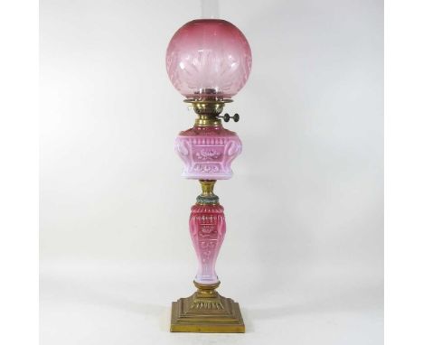 An 19th century French pink opaline glass oil lamp, 88cm high overallCondition report: Reservoir has crack across one side an