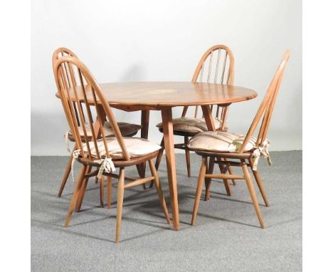 An Ercol light elm drop leaf dining table, together with a set of four matching spindle back dining chairs124w x 113d x 71h c