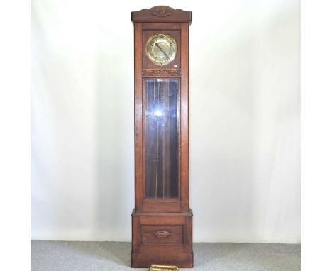 A 1920's oak cased longcase clock, with a glazed case, having an eight day movement215cm high
