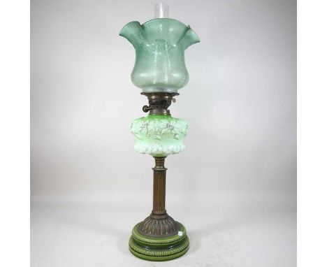 An 19th century brass oil lamp, with an opaque glass reservoir, Duplex burner and etched green glass frilled shade, 71cm high