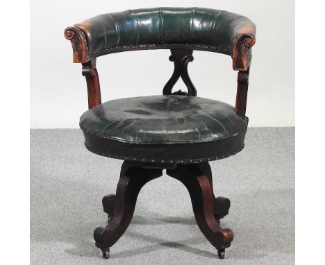 A 19th century mahogany and leather upholstered revolving desk chair, on splayed legs