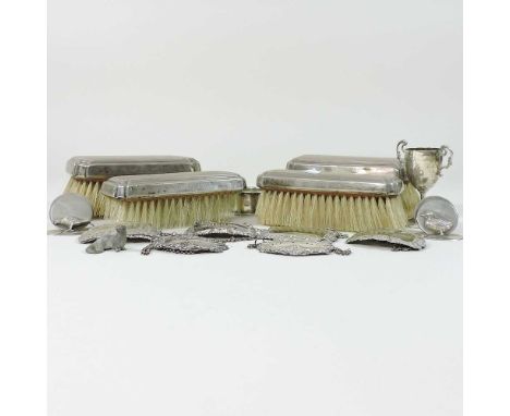 Three silver decanter labels, together with four others, two silver place card holders, four silver backed dressing table bru