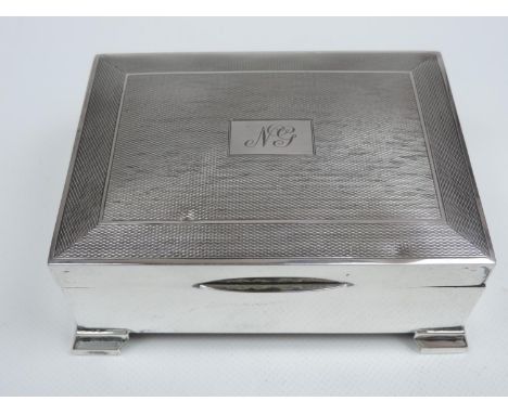 A Silver Cigarette Box - Engine Turned Cover with Initialled Cartouche, Cedar Wood Lining on Four Stepped Feet - Hallmarked f