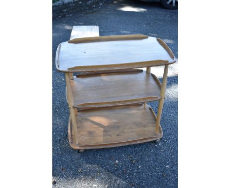 A vintage Ercol 'Blonde' three tier trolley, 70cm wide.This lot can only be collected on Saturday 1st August (10-2pm) 