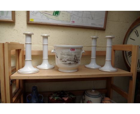A set of four Brownfield white and gilt pottery candlesticks,&nbsp;21cm high; together with a Copeland Spode jardiniere. 