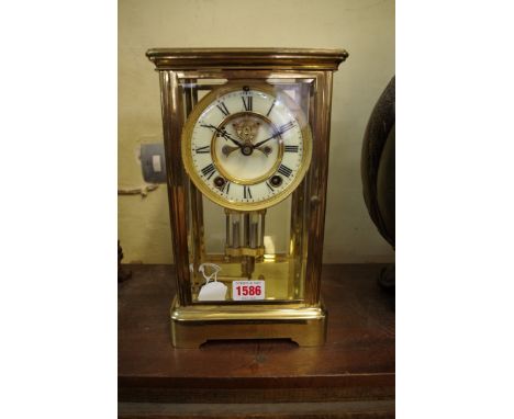 An Ansonia brass four glass mantel clock,&nbsp;with exposed escapement and mercury pendulum, 27.5cm high, with winding key. 