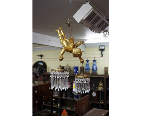 A gilt cherub hanging ceiling light,&nbsp;with two light fittings and faceted glass drops. 