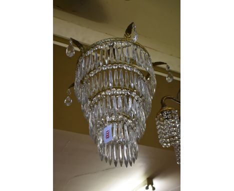 A vintage gilt brass four tier ceiling light, having cut glass drops,&nbsp;33cm excluding fitting. 