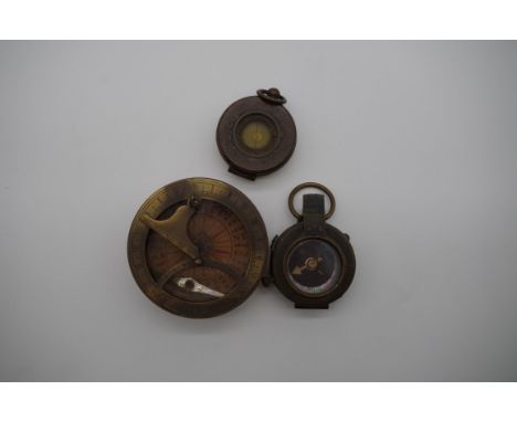 A brass sundial compass, stamped 'Elliot, London',&nbsp;the outer case stamped 'A J Carlisle, London, 1912', 8.7cm diameter; 