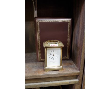 A brass carriage clock by Matthew Norman, numbered 1754, 11cm high, with fitted case and key. 