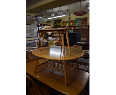 A vintage Ercol 'Blonde' circular low occasional table, 98cm long; together with a nest of two Ercol 'Blonde' pebble tables. 