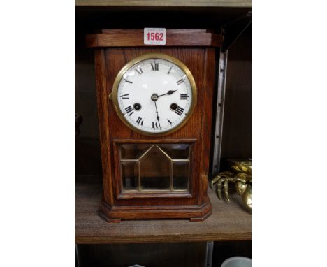 An oak striking mantel clock, by F M S, 32cm high, with pendulum and key.&nbsp;&nbsp; 