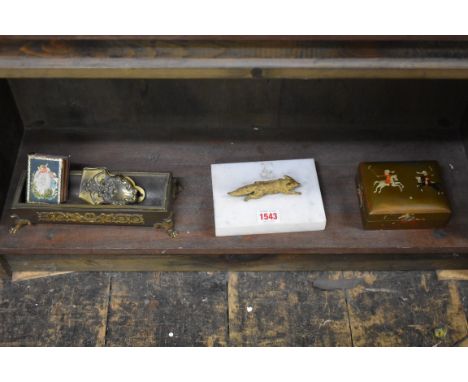 A French gilt brass trough shaped pen tray, 21cm; together with an old stamped brass paperclip, decorated green man; a fox pa