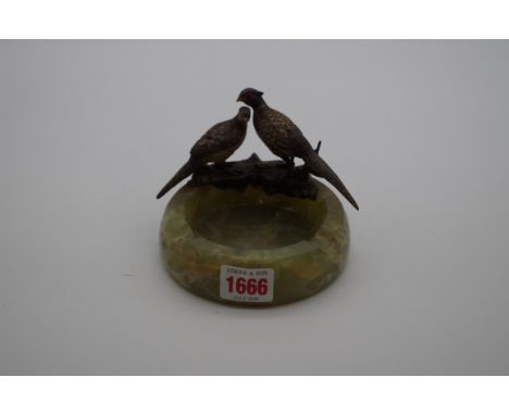 An onyx ashtray, mounted with cold painted peacock and peahen. 