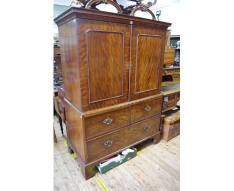 A 19th century mahogany linen press,&nbsp;having pair of panel doors above two short and one long drawer, on bracket feet, 13