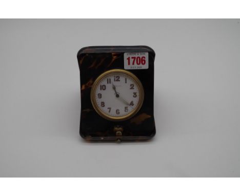 An early 20th century tortoiseshell eight day travelling clock,&nbsp;12cm high.&nbsp; 