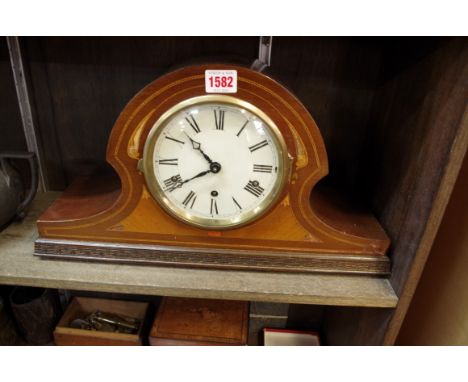 An Edwardian inlaid mahogany striking mantel clock,&nbsp;45.5cm wide, with pendulum and key, (s.d.).&nbsp; 
