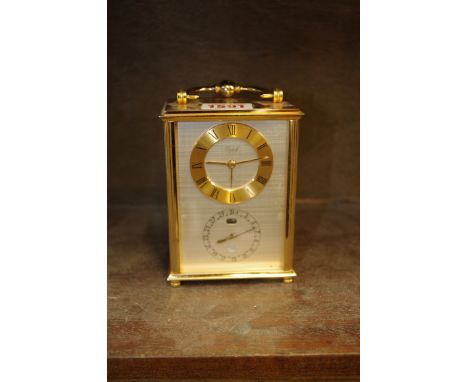 A vintage brass carriage type mantel clock, by Imhof, engraved presentation to rear door, total height including handle 15cm.