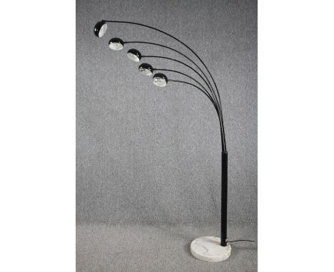 A modern floor lamp with five arms of lights and a marble base. H.198cm. 