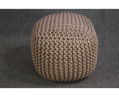 A contemporary knitted pouffe. H.43 W.50 D.50cm. 