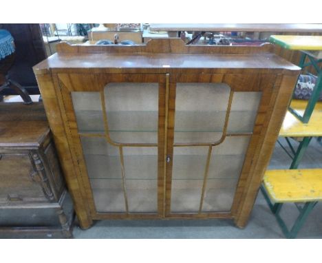 An Art Deco walnut two door display cabinet