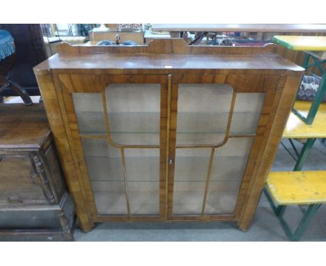 An Art Deco walnut two door display cabinet