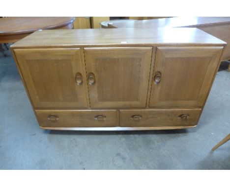 An Ercol Golden Dawn elm sideboard