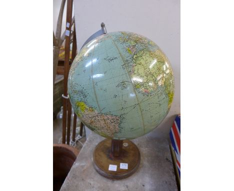 A terrestrial globe on a wooden stand with compass set to base