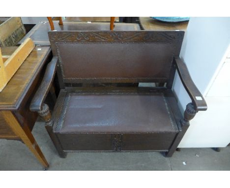 A carved oak monks bench